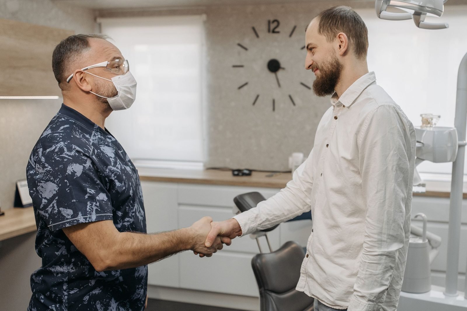 A dentist reassuring a nervous patient.