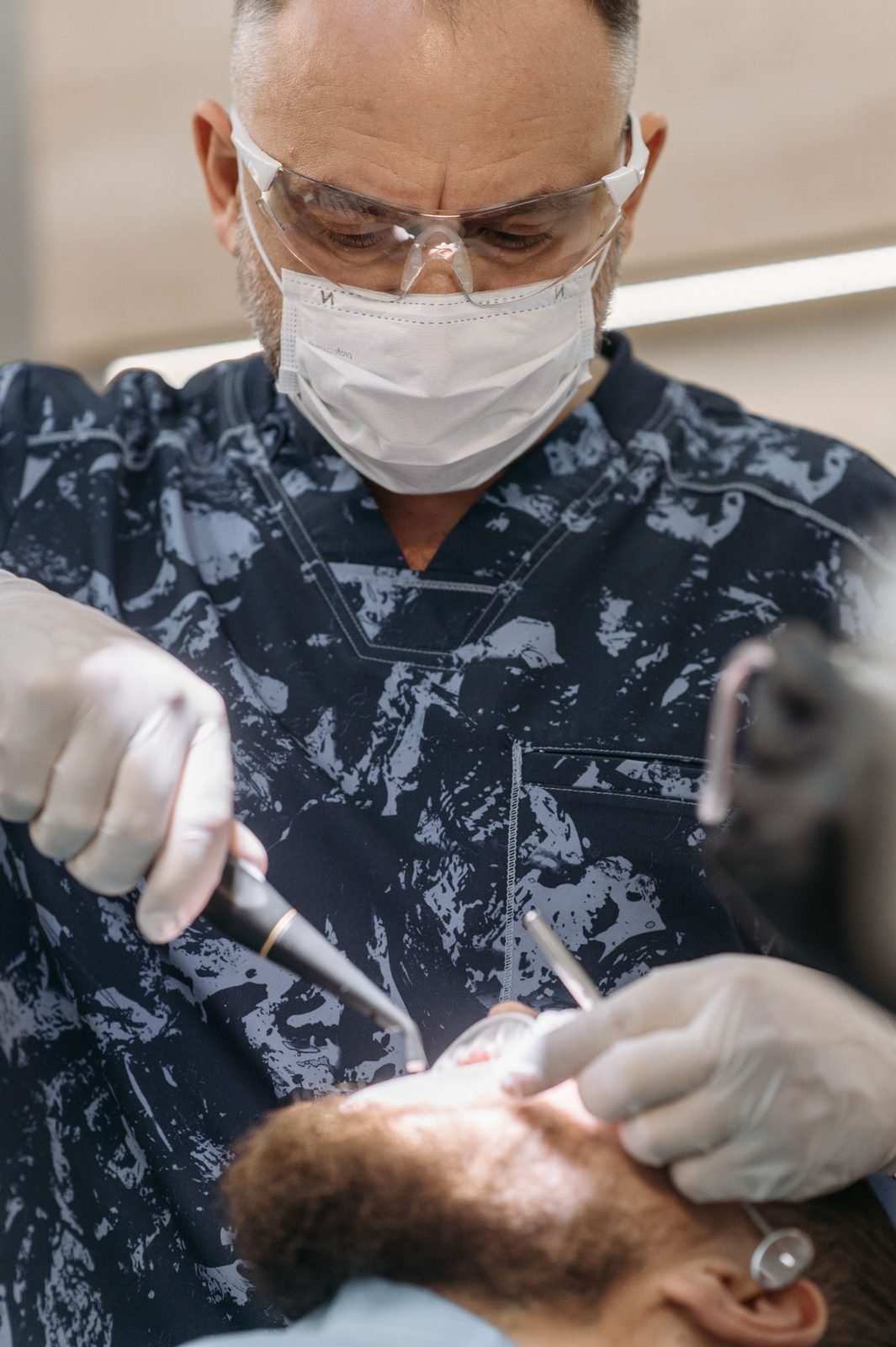 A dentist working under a treatment microscope.